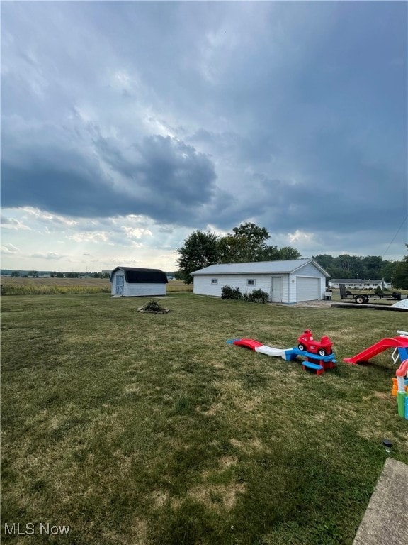 view of yard featuring an outbuilding and a garage