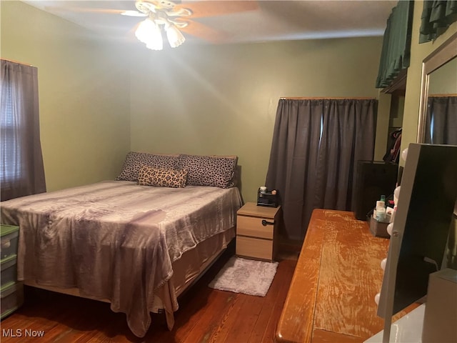 bedroom featuring ceiling fan and dark hardwood / wood-style flooring