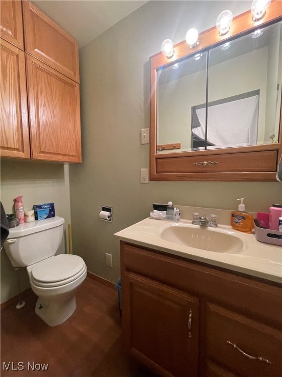 bathroom featuring vanity and toilet