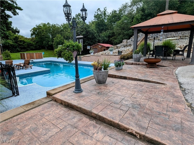 view of swimming pool with a gazebo and a patio area