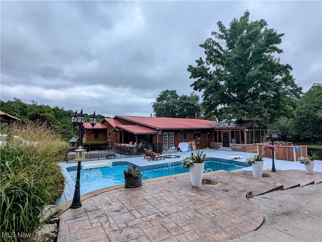 view of swimming pool with a patio area