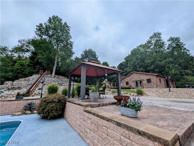 view of patio / terrace featuring an outdoor structure and a gazebo
