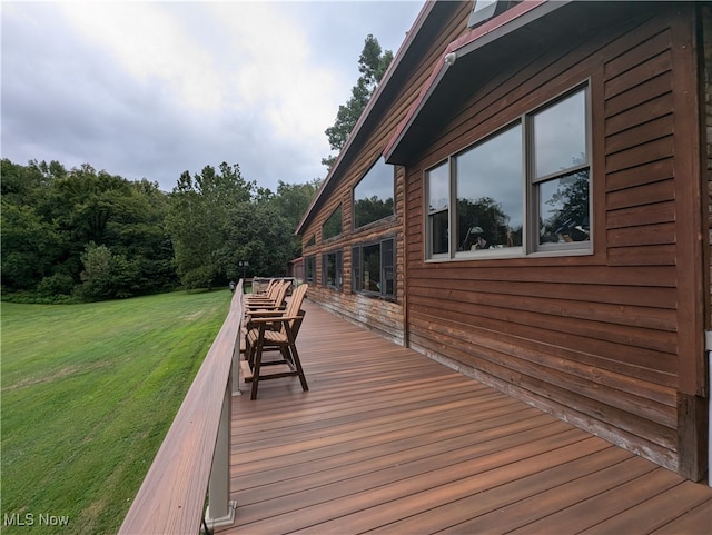 wooden terrace with a yard