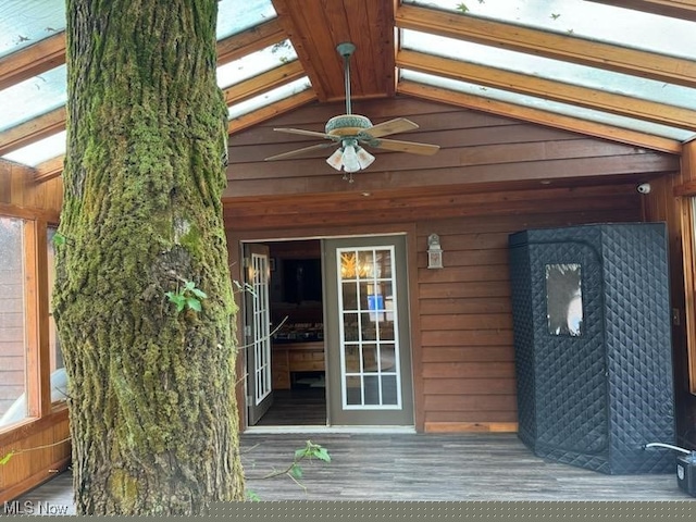property entrance featuring ceiling fan and a deck