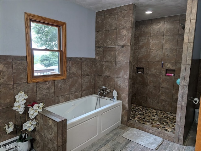 bathroom with separate shower and tub, tile walls, and hardwood / wood-style flooring