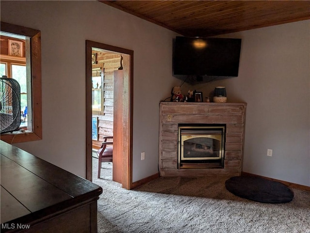 living area with wood ceiling, baseboards, a premium fireplace, and carpet floors