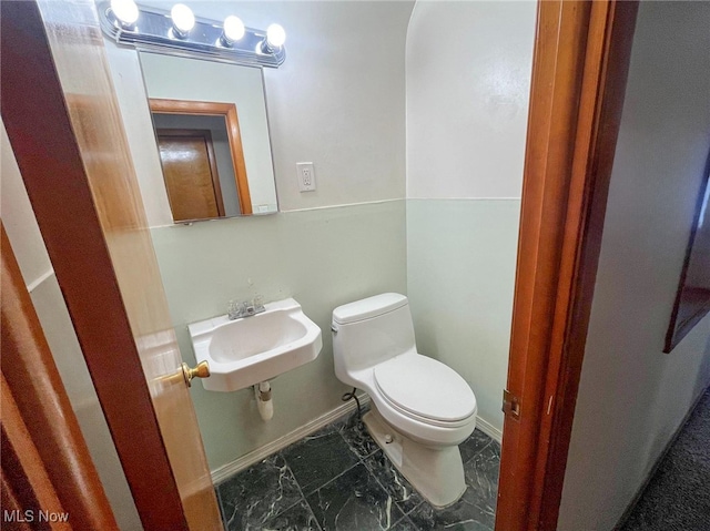 bathroom featuring sink and toilet