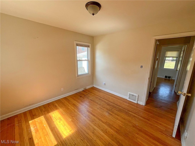 spare room featuring wood-type flooring