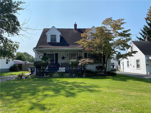 cape cod home featuring covered porch and a front lawn