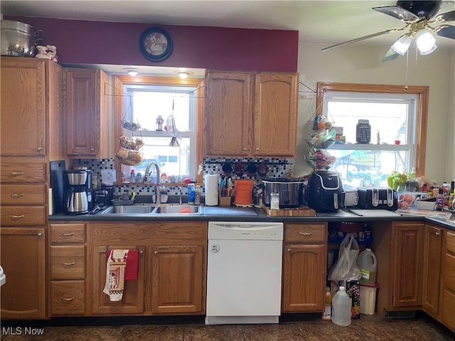 kitchen featuring ceiling fan, dishwasher, tasteful backsplash, and sink