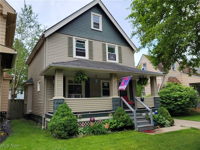 view of front of home featuring a front yard and covered porch