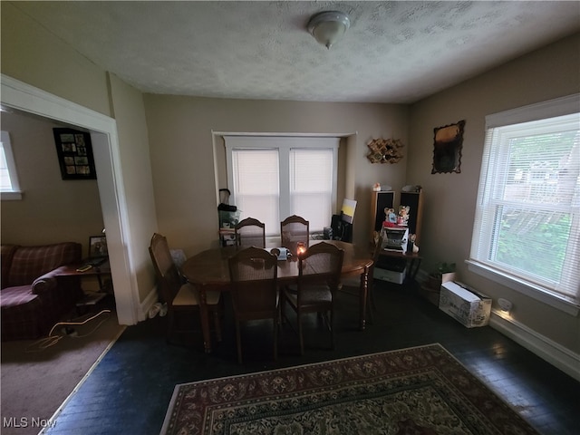 dining area featuring a textured ceiling