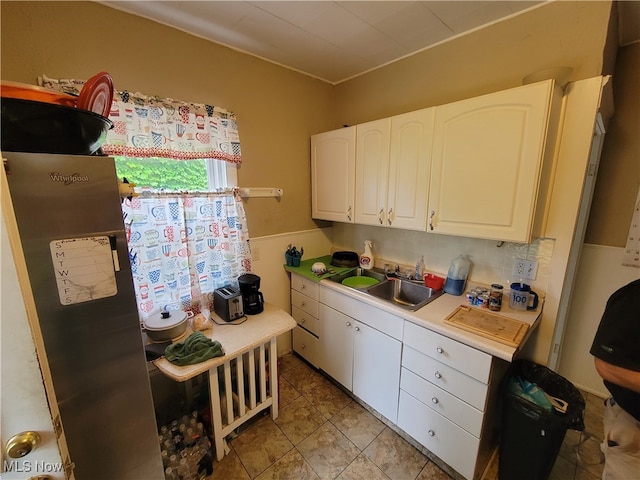 kitchen featuring white cabinetry and sink