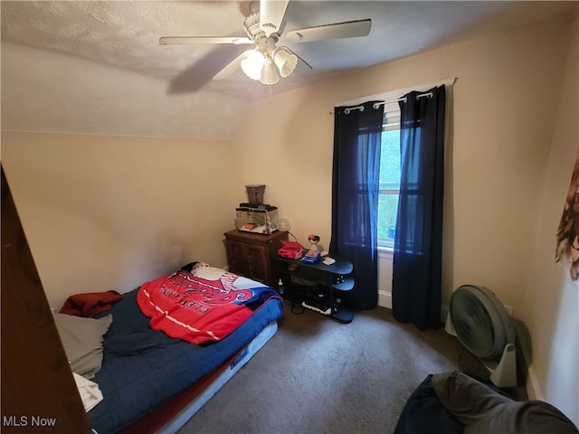 carpeted bedroom featuring lofted ceiling, ceiling fan, and a textured ceiling