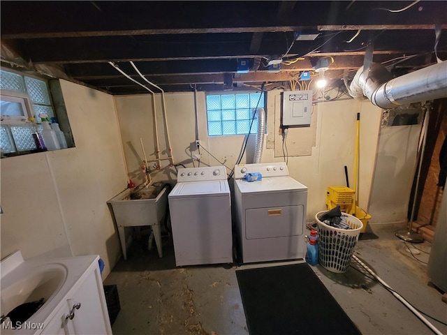 washroom featuring washing machine and dryer and sink