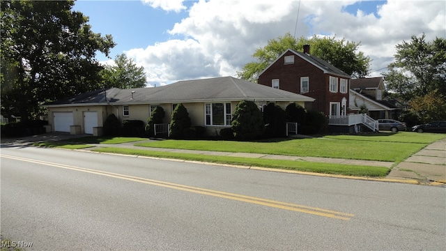 view of front of property with a garage and a front yard