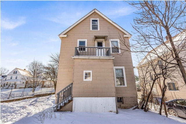 snow covered house with a balcony