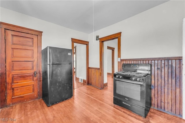 kitchen featuring black appliances and wood-type flooring