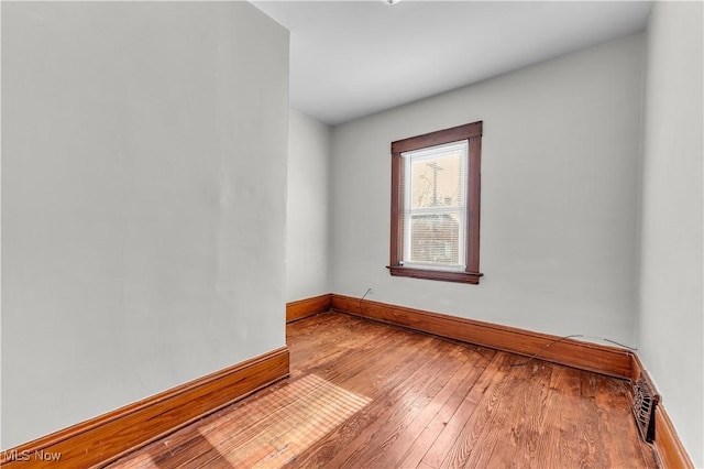 unfurnished room with hardwood / wood-style floors