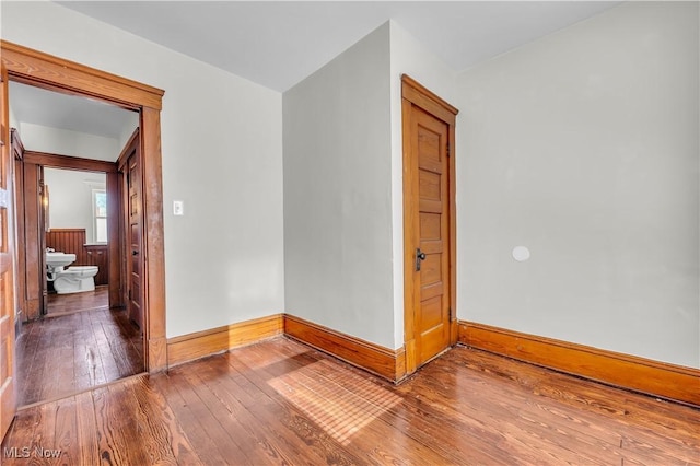 spare room featuring wood-type flooring