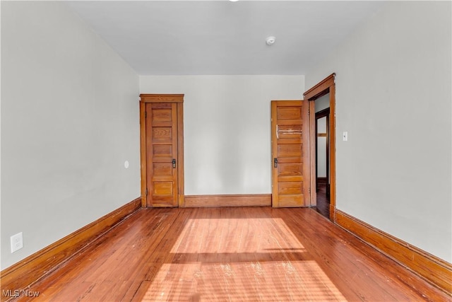 spare room with wood-type flooring