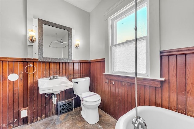 bathroom with a tub, sink, and toilet