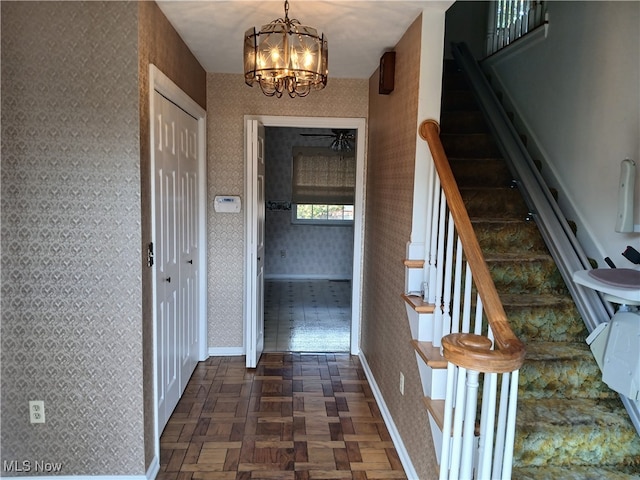 interior space with parquet floors and an inviting chandelier