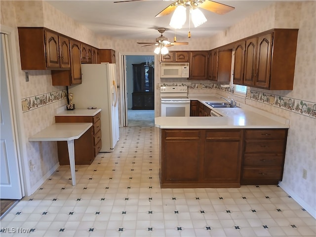 kitchen with kitchen peninsula, ceiling fan, sink, and white appliances