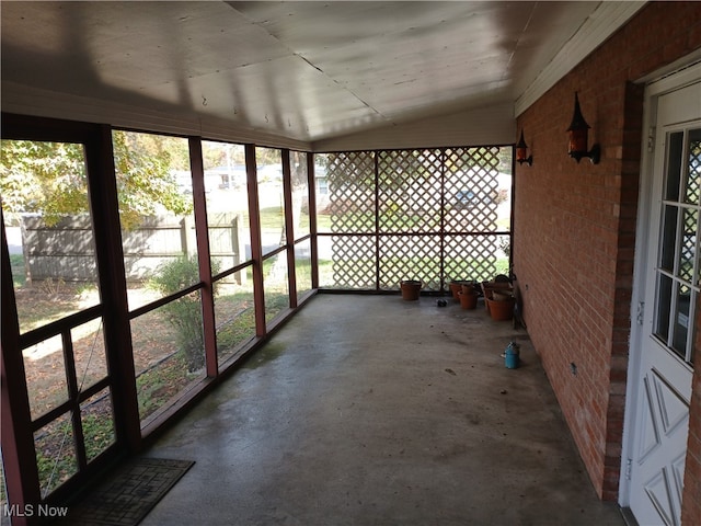 unfurnished sunroom with vaulted ceiling and plenty of natural light