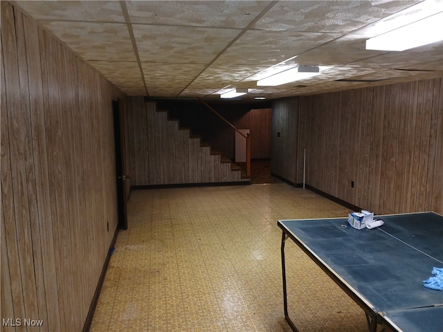 basement featuring wood walls