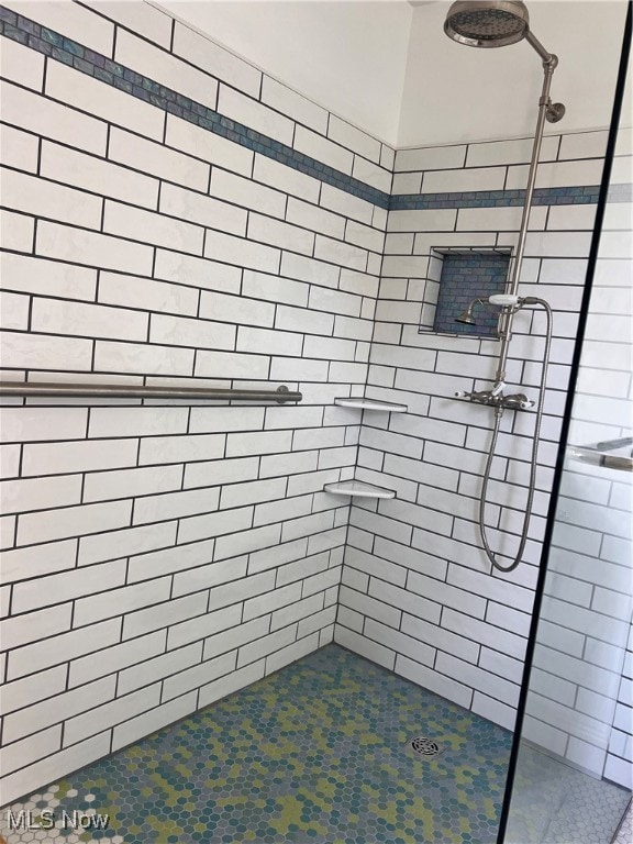 full bath with a tile shower