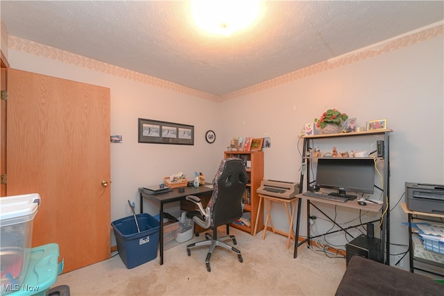 carpeted office featuring a textured ceiling