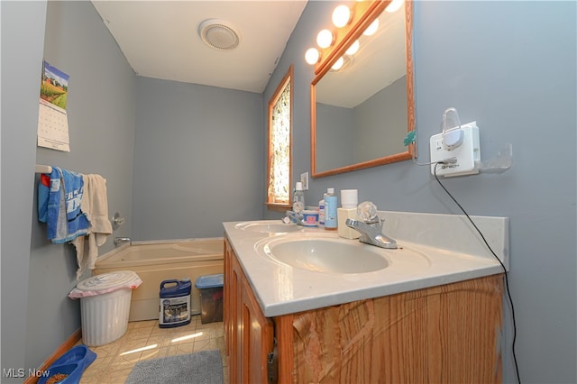 bathroom with vanity, a bath, and tile patterned floors