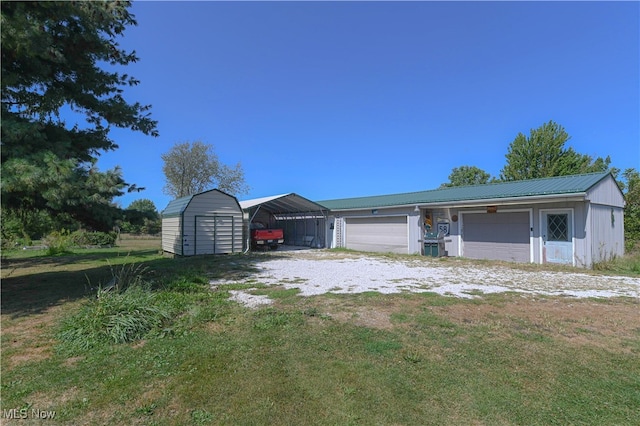 ranch-style house featuring a storage shed, a front lawn, and a carport