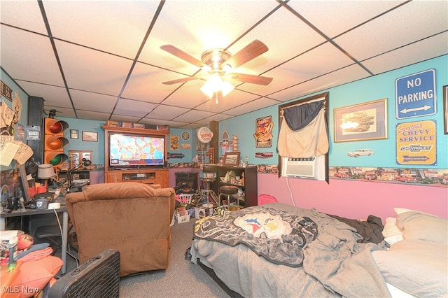 interior space with cooling unit, carpet flooring, ceiling fan, and a drop ceiling