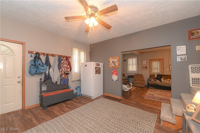 interior space with ceiling fan, hardwood / wood-style flooring, plenty of natural light, and a textured ceiling