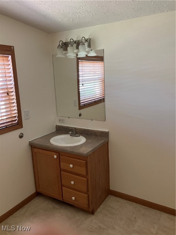 bathroom featuring a textured ceiling and vanity