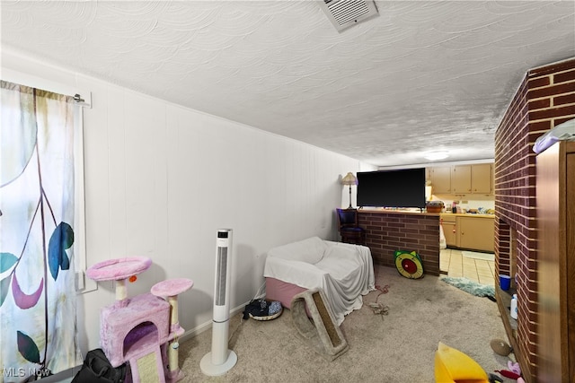 carpeted bedroom featuring a fireplace and a textured ceiling