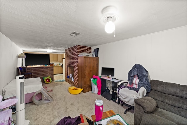 recreation room with carpet flooring, a textured ceiling, and a fireplace