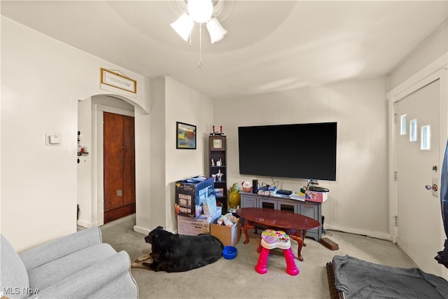 living room featuring light colored carpet and ceiling fan