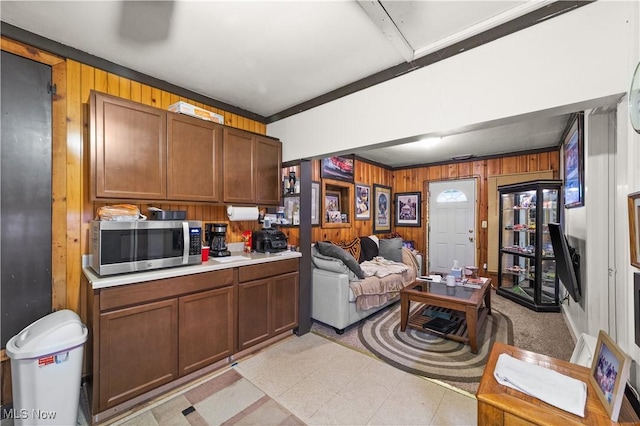 kitchen with crown molding and wood walls