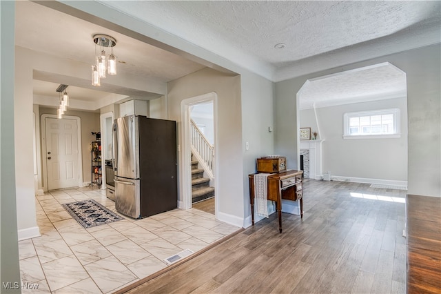 interior space featuring a textured ceiling and light hardwood / wood-style floors