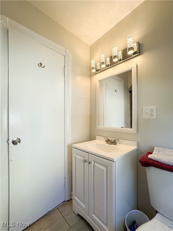 bathroom featuring vanity, toilet, and tile patterned floors