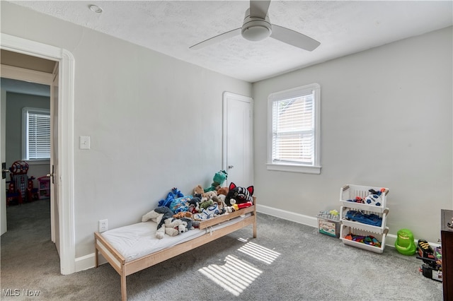 game room with ceiling fan, a textured ceiling, and carpet floors