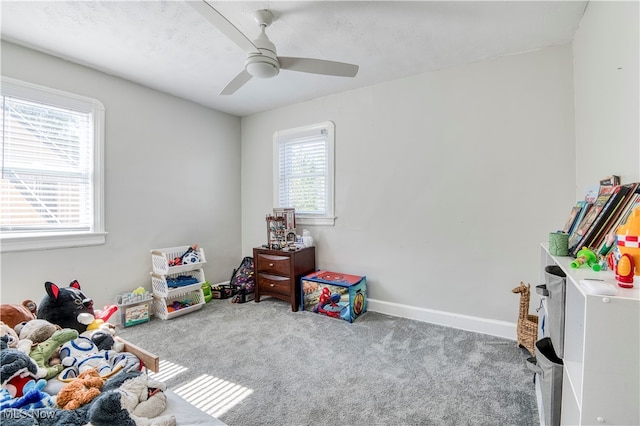 recreation room with carpet flooring and ceiling fan