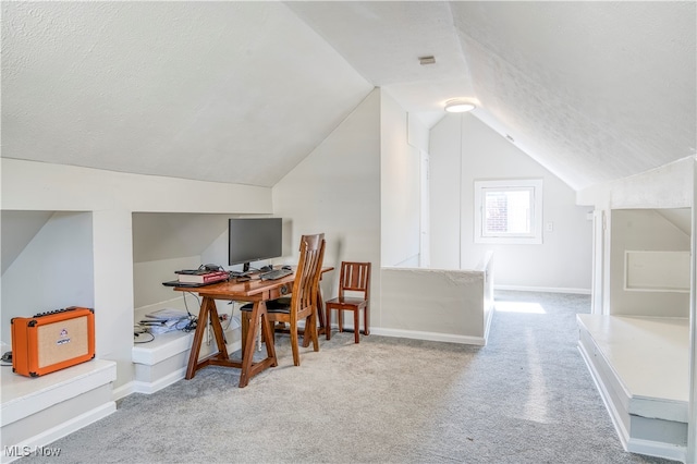 home office featuring a textured ceiling, lofted ceiling, and carpet