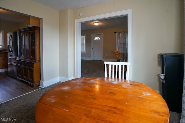 dining area with dark carpet