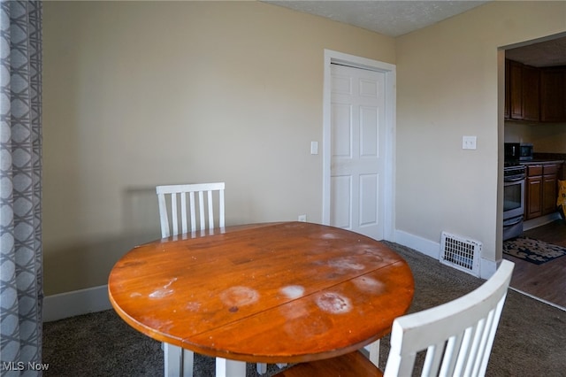 dining room with dark hardwood / wood-style flooring