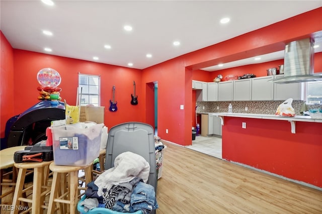 playroom featuring bar area and light hardwood / wood-style floors