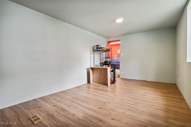 unfurnished room with hardwood / wood-style floors